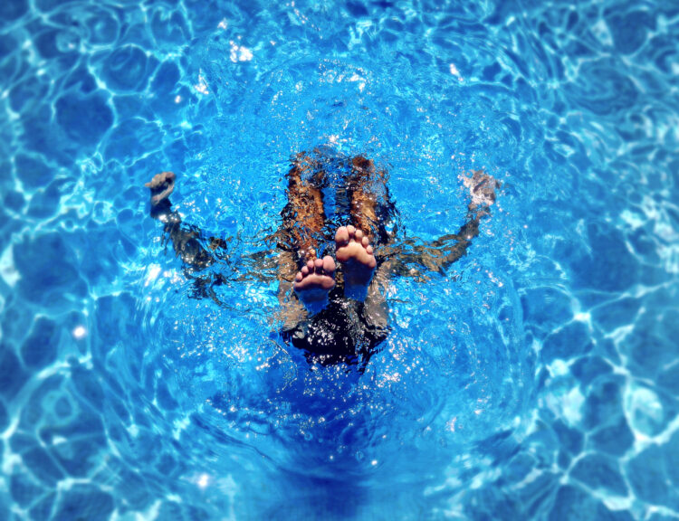 Freedom Pools maintenance technician servicing pool equipment in Pensacola